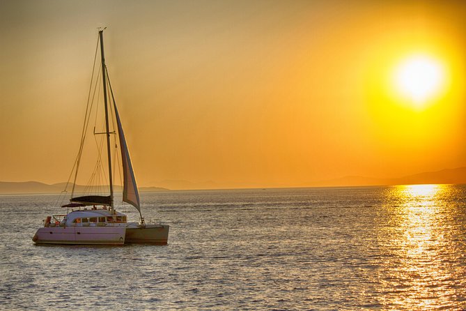 Catamaran Day & Sunset Cruises with meals Drinks and transportation - Rhenia island cove: 2 hours of swimming and snorkelling gear included