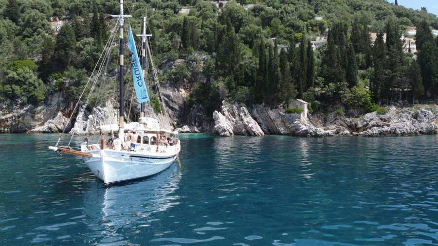 Corfu Town: Full-Day Cruise with Lunch, Drinks & Swim Stops - Swim stop #1 near Nissaki: cliffs, clear water, quick snorkel time