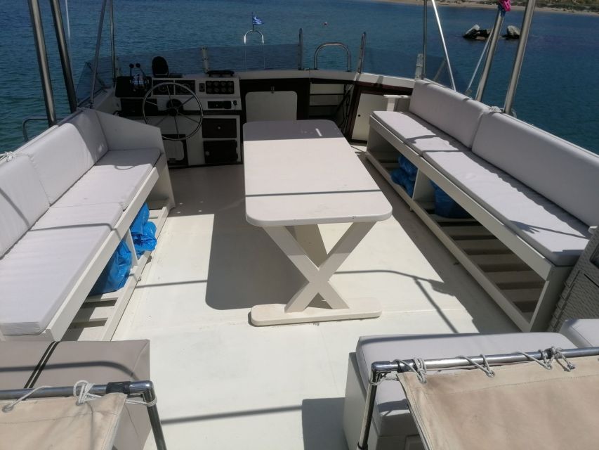 Crete: Snorkeling Boat Trip with Lunch and Transfer - Saint George Bay: sunbathing with rocky coastline views