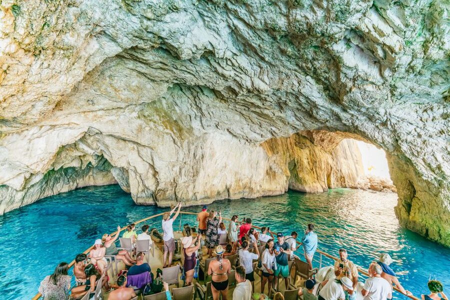 From Corfu Island: Antipaxos & Paxos Blue Caves Boat Cruise - The Monks, the Cliffs, and the Paxos Sea Story Your Guide Explains