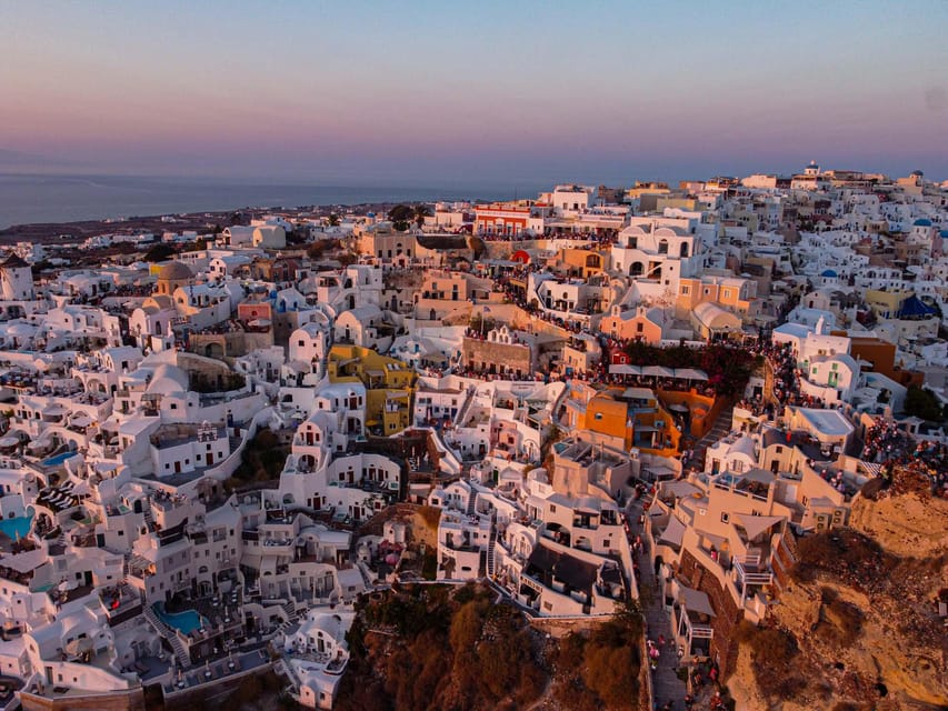 From Fira: Santorini Highlights Minibus Tour with Oia Sunset - Perissa Beach free time: black sand, swimming, and a lunch break that matters