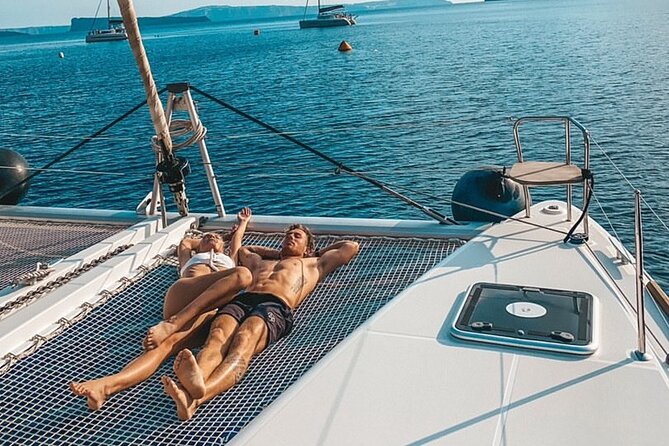 Half-Day Exclusive Catamaran Cruise in Santorini with Meal and Open Bar - Hotel pickup, onboard comfort, and a small-group feel (18 max)