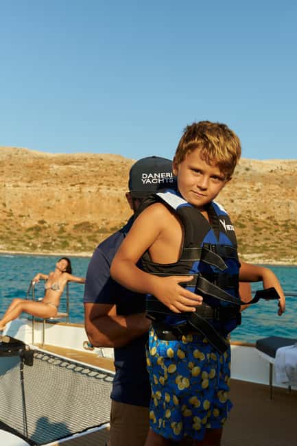 Luxury Catamaran to Balos: Sunset, Snacks, Drinks & Transfer - Balos Lagoon break time: pink sand, swimming options, and built-in toys