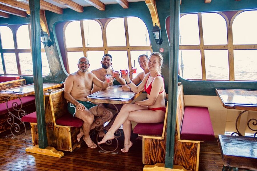 Rhodes: All Inclusive Day Cruise with BBQ & Unlimited Drinks - Onboard comfort: bean bags upstairs vs tables downstairs