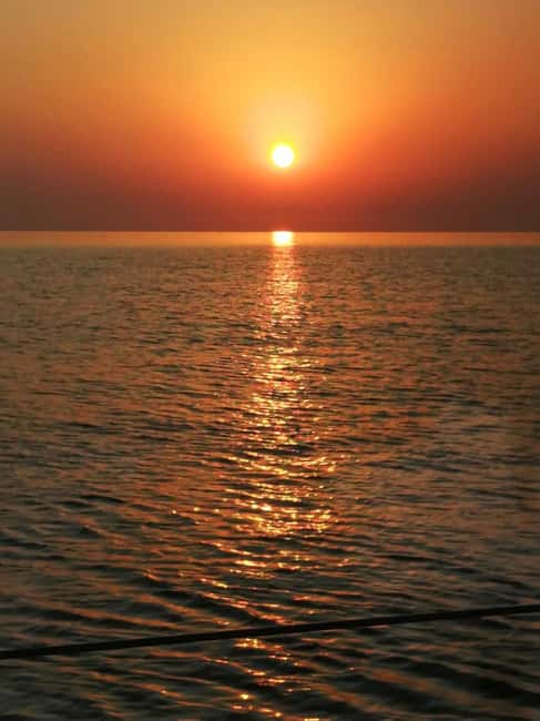 Rhodes: Sunset Catamaran Cruise with Snack, Fruits & Drinks - Kalithea Springs Bay: Your One-Hour Window for Swimming and Watersports
