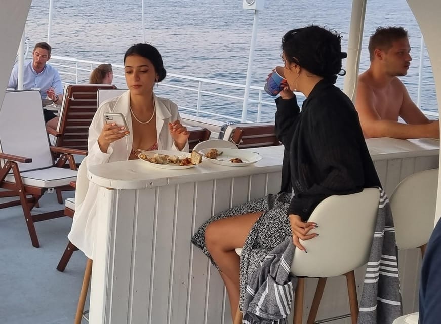 Rhodes: Sunset Cruise with Live Music, Wine & Greek Buffet - Kalithea Springs Swim Stop: Photos, snorkeling gear, and the famous seaside monument
