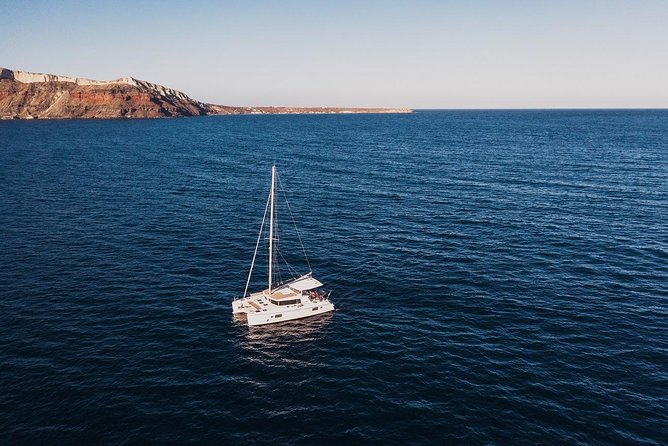 Romantic Sunset Catamaran Caldera Cruise incl. Meal & Drinks - Thermal hot springs and Aegean snorkeling, with real-world expectations