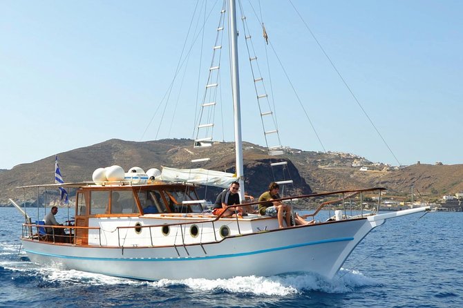 Santorini Caldera Sunset Traditional Cruise with Meal and Drinks - Akrotiri lighthouse pass: coastline views from the cliff edge