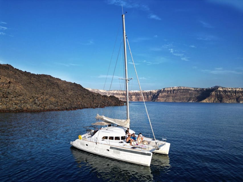 Santorini: Catamaran Cruise with Greek BBQ and Drinks - Akrotiri Viewpoints, Indian Rocks, and the Venetian Lighthouse Photo Moments