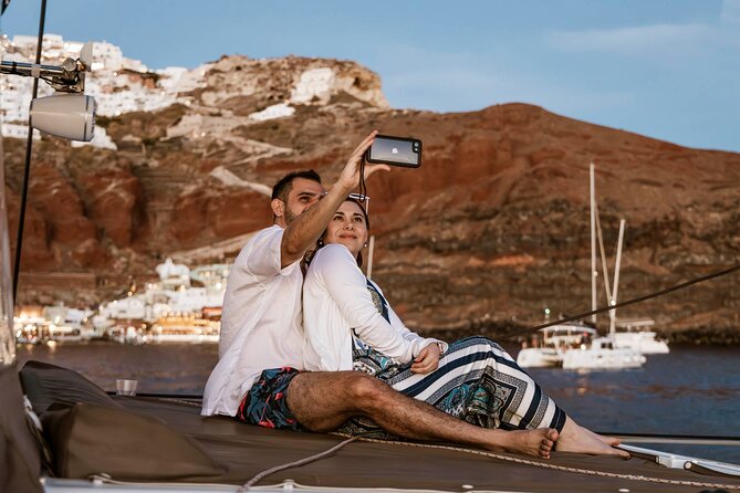 Santorini Catamaran Cruise with Greek Meal, Open-Bar and Sunset - First Swim Stop: Nea Kameni Hot Springs (Warm, Sulfur, and Time-Limited)