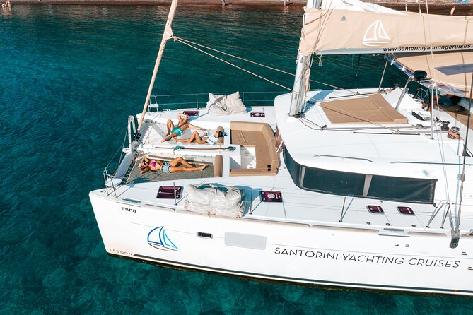 Santorini Catamaran Cruise: with Lunch, BBQ, Open Bar, Transfers - Red Beach at your pace, plus an easy swim setup