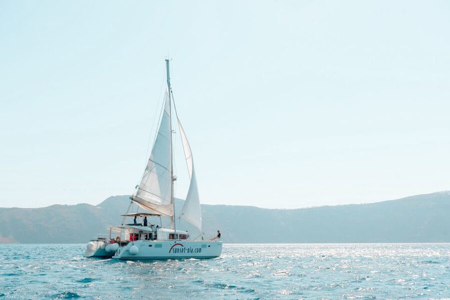 Santorini: Catamaran Tour with BBQ Meal and Unlimited Drinks - Sunset from Oia: a different way to see the caldera glow