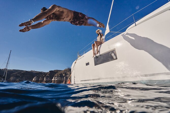 Santorini Oia: Luxury Sunset Cruise with Fresh Fish BBQ & Drinks - Thirassia: the calm swim stop near Oia