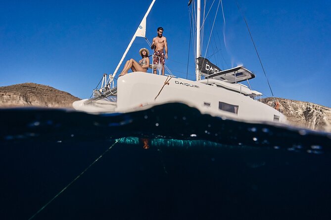 Santorini Oia: Luxury Sunset Cruise with Fresh Fish BBQ & Drinks - The Santorini volcano waters: sulfur springs and black rock drama