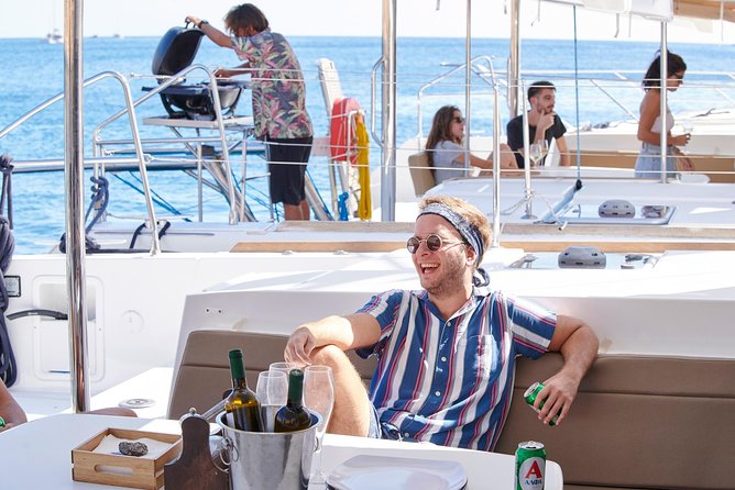 Santorini Platinum Catamaran Cruise with Meal, BBQ and Open Bar - White Beach and the sailing stretch toward Akrotiri’s lighthouse