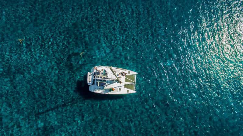 Santorini: Private Catamaran Cruise with Food & Drinks - Red Beach and White Beach photo stops, plus the Akrotiri lighthouse views