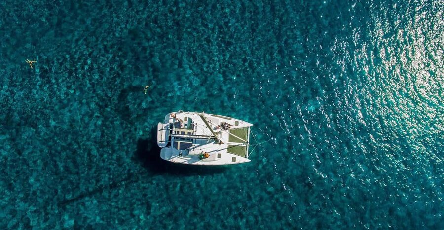 Santorini: Private Catamaran Cruise with Food & Drinks - Aspronisi and the volcanic stop chain: where the swimming gets real