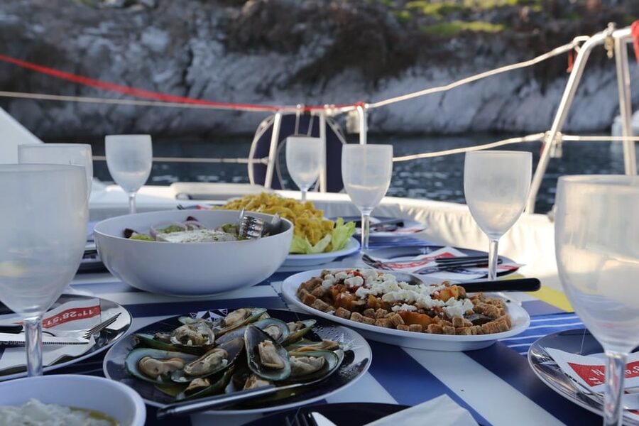 Santorini: Private Catamaran Cruise with Food & Drinks - Lunch onboard: wine, beer, and a meal that is mostly Greek, even when the label is seafood