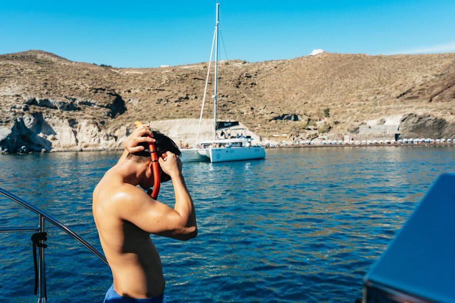 Santorini: Sailing Catamaran Cruise with BBQ and Drinks - Sunset cruise vibes over the Aegean, with the boat timed for light