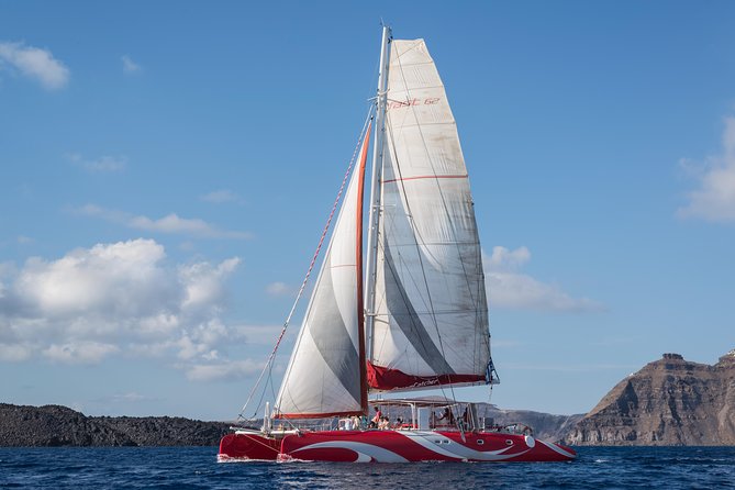 Santorini Sailing Dream Catcher with BBQ Lunch and Drinks - On-deck comfort on a catamaran: views, shade, and staying dry