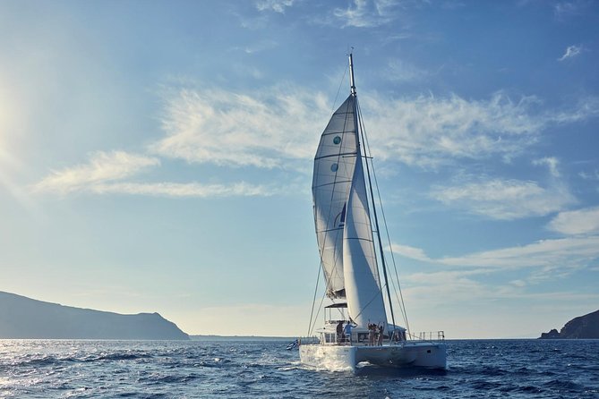 Santorini Sunset Luxury Sailing Catamaran Cruise with BBQ, drinks, transfer - Caldera cruising: Ancient Lighthouse views, Palea Kameni, and volcano sailing