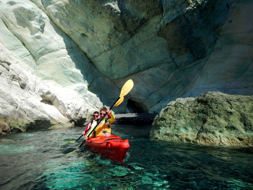 Santorini: Sunset Sea Kayak with Light Dinner - Sea Caves and the Black Mountain Sunset View