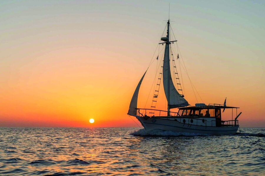 Santorini: Traditional Wooden Boat Tour with Meal and Wine - Akrotiri Lighthouse and the Caldera’s Volcanic Theater